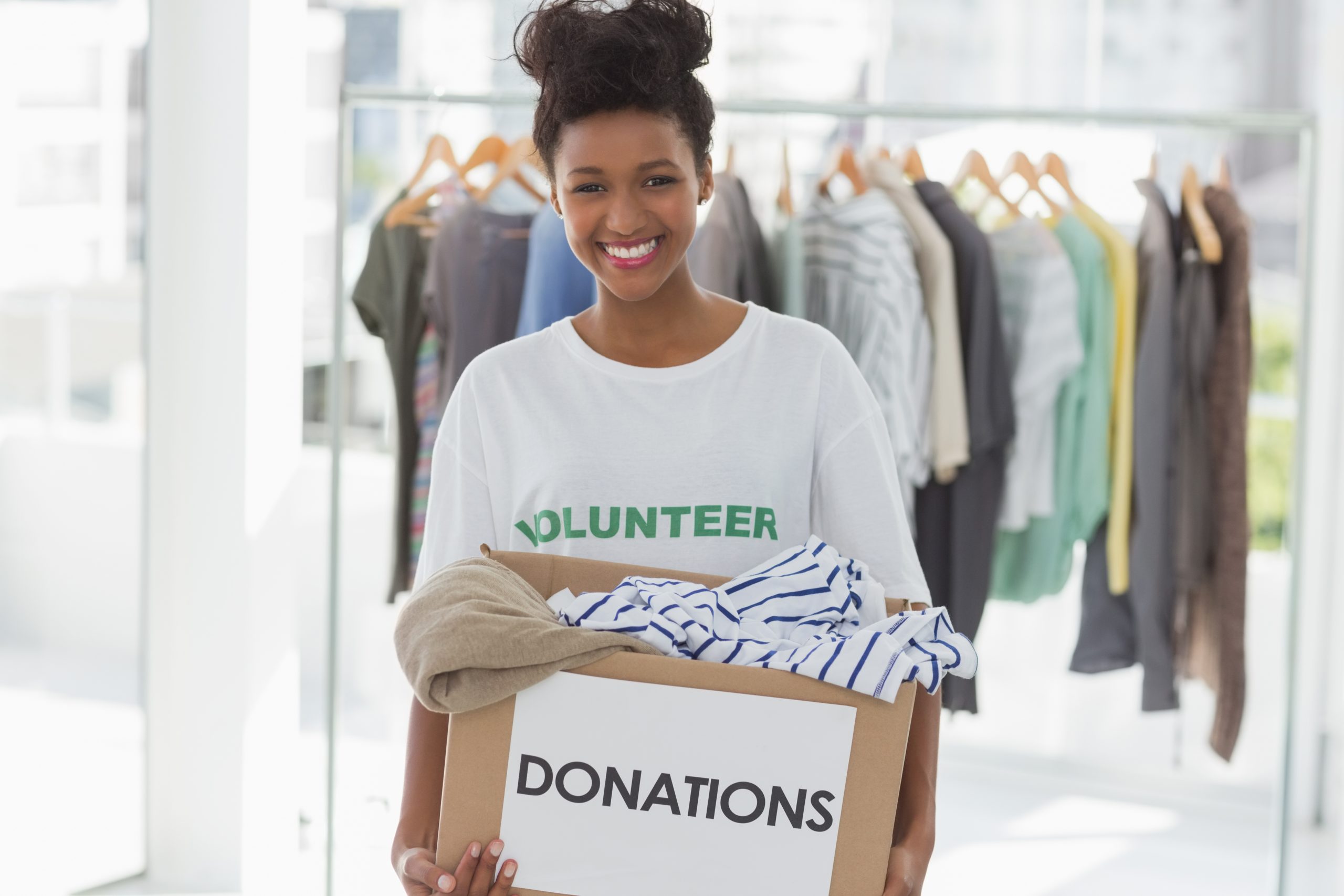 Smiling young woman with clothes donation